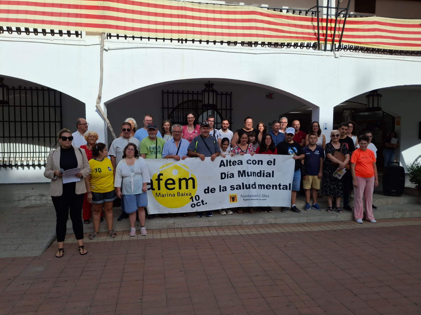 La Asociación de Familiares y Enfermos Mentales de la Marina Baixa, AFEM, y la Corporación Municipal cuelgan una pancarta en el balcón del Ayuntamiento para sensibilizar a la sociedad sobre las enfermedades mentales y sus consecuencias, con motivo del Día Mundial de la Salud Mental que se celebra el 10 de octubre. Además protagonizaron esta mañana un taller de baile que tuvo lugar en la misma plaza.